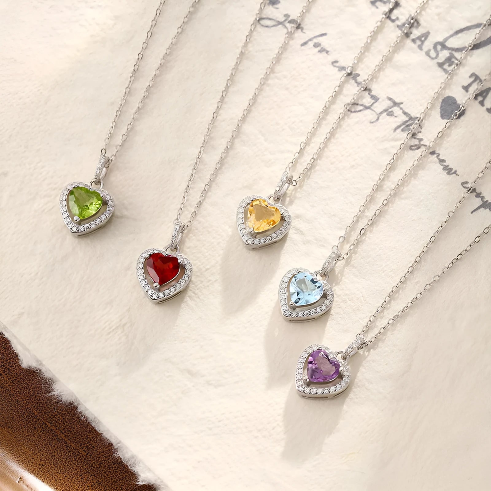 S925 sterling silver necklace with a heart-shaped pendant featuring a round natural gemstone on a cross chain.