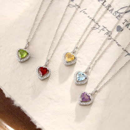S925 sterling silver necklace with a heart-shaped pendant featuring a round natural gemstone on a cross chain.