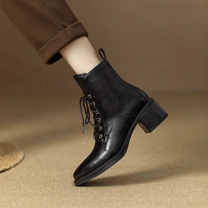 Women's black pointed toe short tube boots with a 5.5cm heel on a white background.