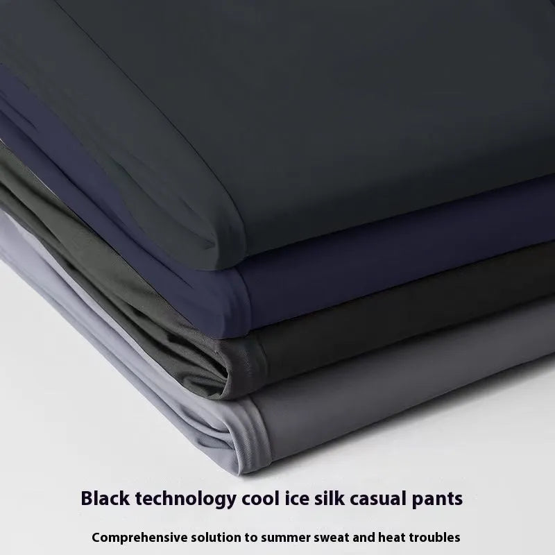 Man wearing black Ice Silk loose-fit casual trousers with an elastic waistband.