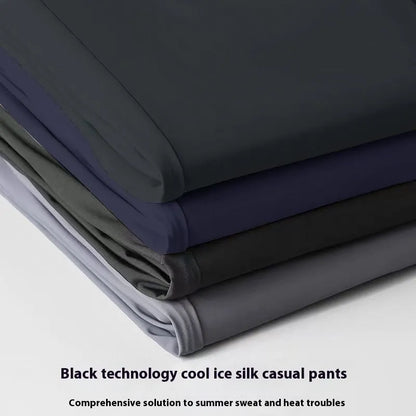 Man wearing black Ice Silk loose-fit casual trousers with an elastic waistband.