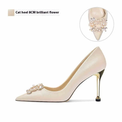 French crystal bridal high heel pump with rhinestones on cloth upper, showing pointed toe and stiletto heel.