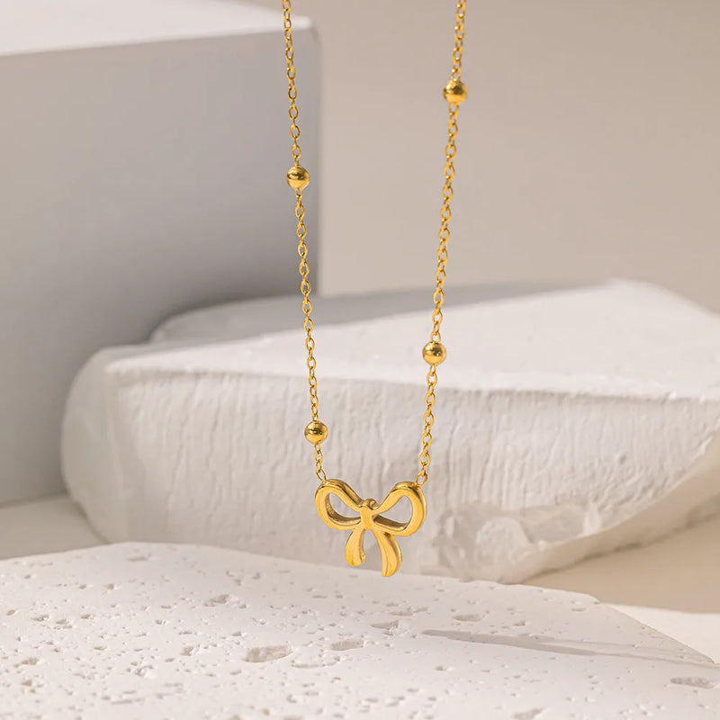European and American fashion bow necklace for women, featuring a 41-50cm adjustable titanium steel chain with a detailed electroplated gold finish and cross-link design for a contemporary look.