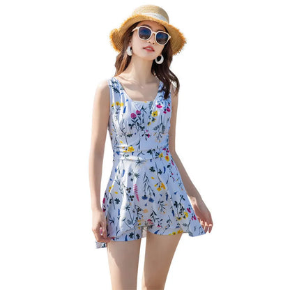 Women's floral print one-piece swimsuit on a hanger, shown in light purple and white colour options.