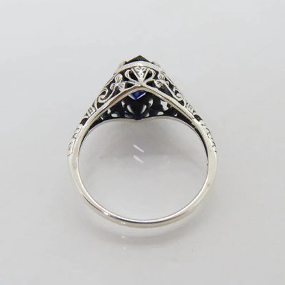 Silver women's ring with geometric hollow pattern and zircon detail on a finger.