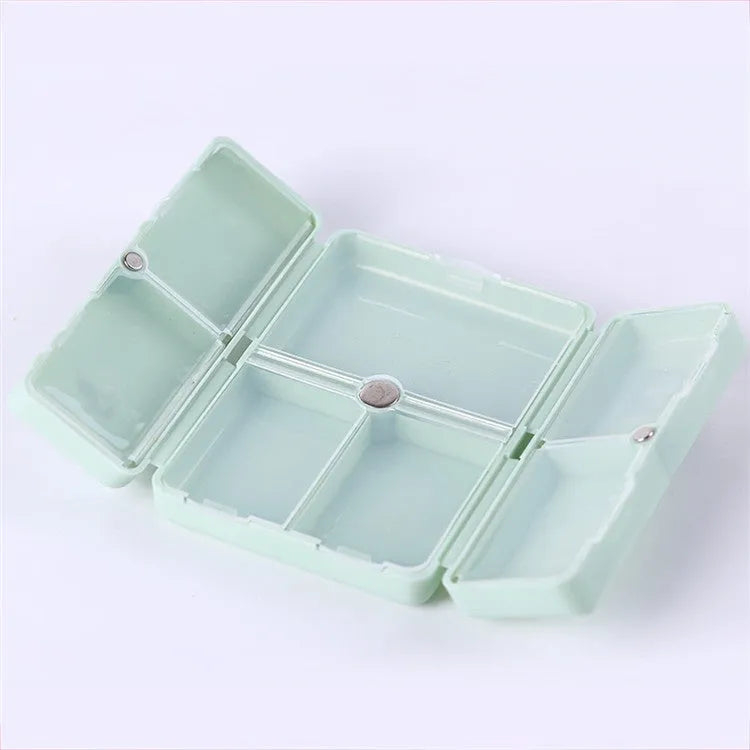 Blue foldable pill box with seven compartments and magnetic closure showing open and closed positions