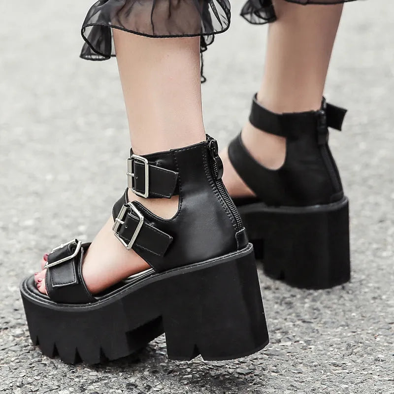 Black punk-style women's sandals with a chunky heel, thick platform sole, round toe, buckle strap, and back zipper.