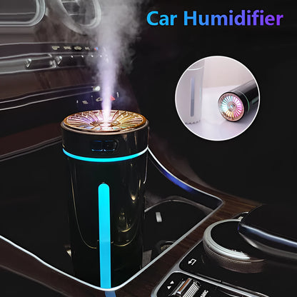 Black portable humidifier with LED lights beside car cup holder showing mist output