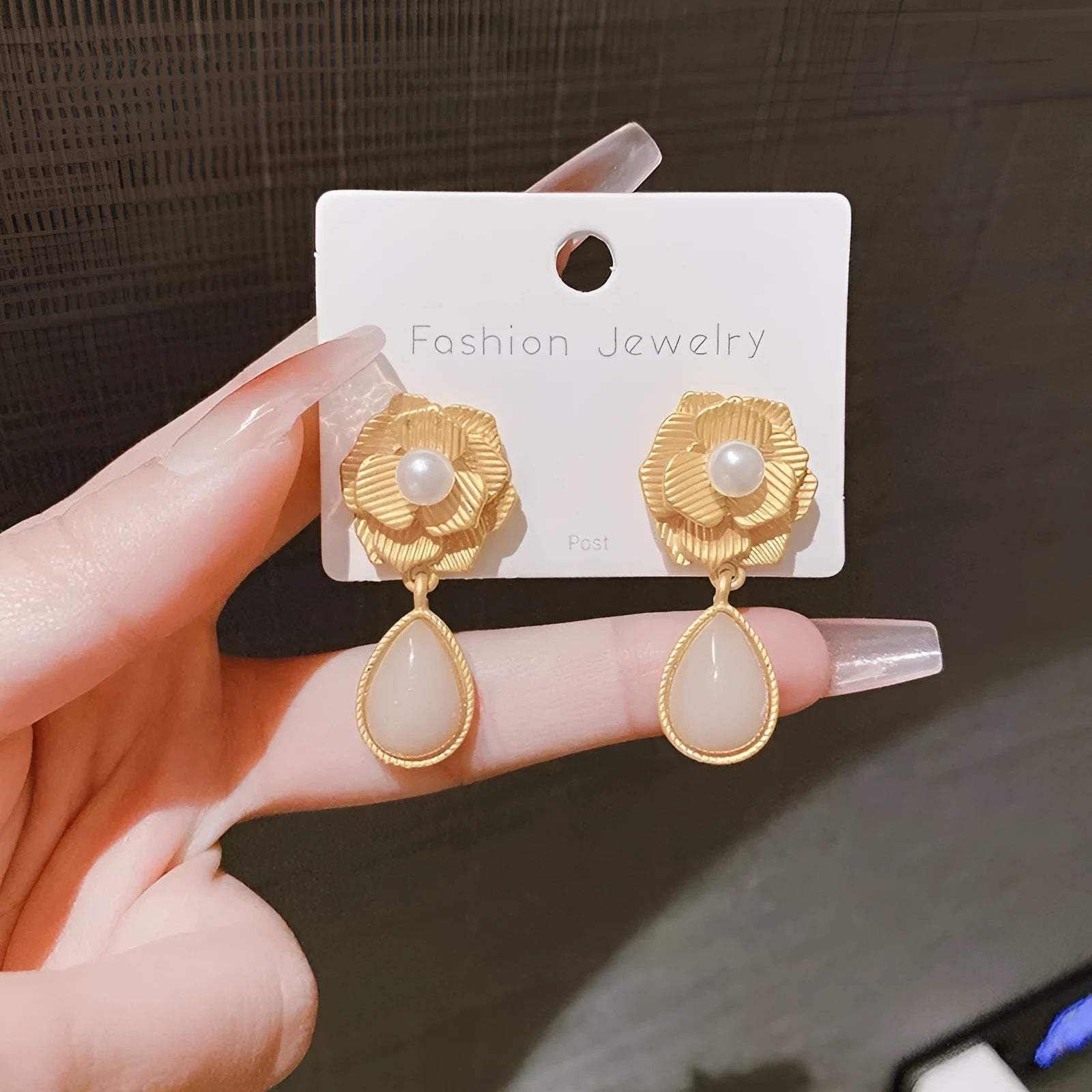 Gold-coloured floral stud earrings with a needle rose design, opal stone, and ice flower details.