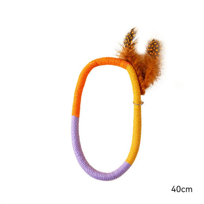 Green circular cotton rope cat toy with feathers and catnip for dental play