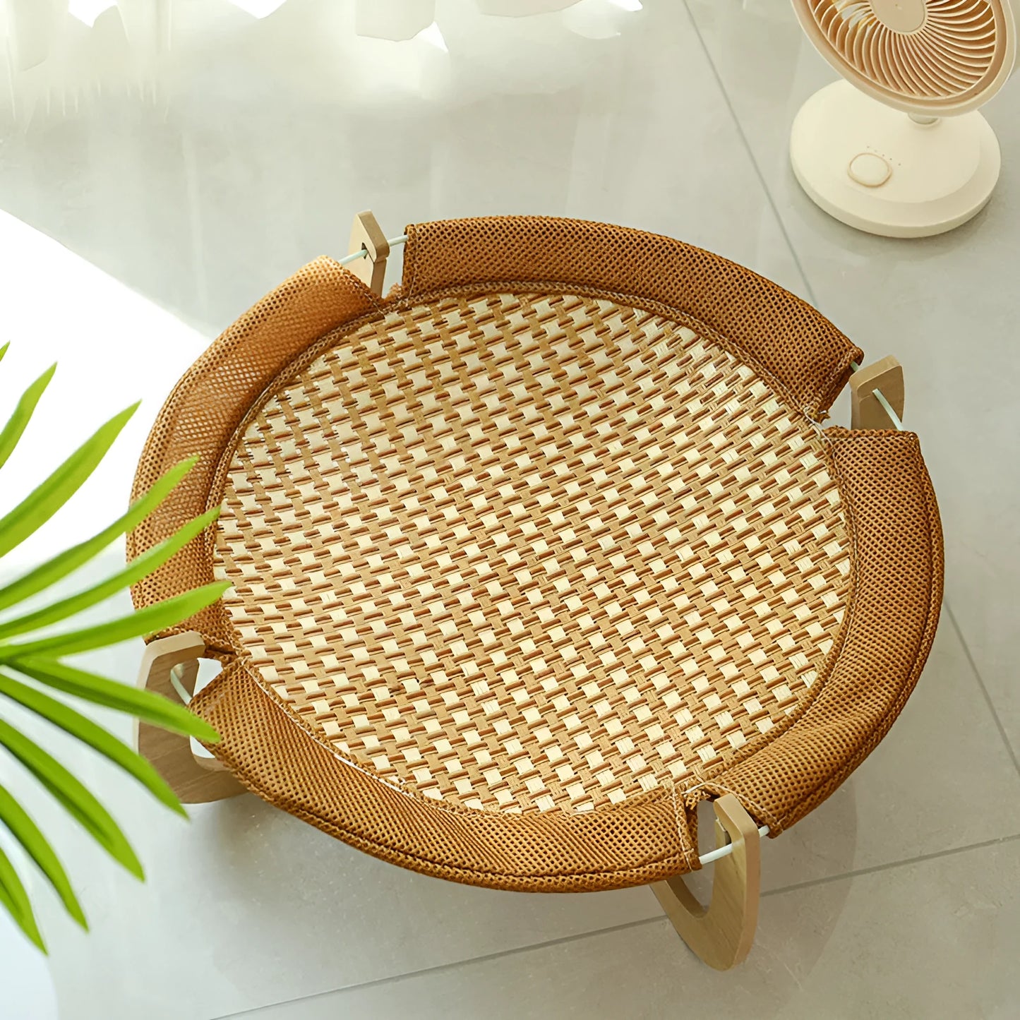 Brown woven rattan pet hammock bed for cats and small dogs on a flat surface.
