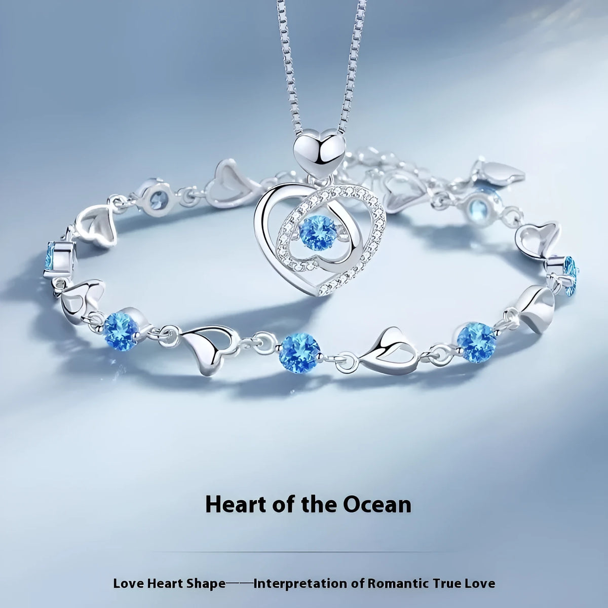 Blue diamond heart-shaped pendant necklace and matching bracelet set on a copper chain.
