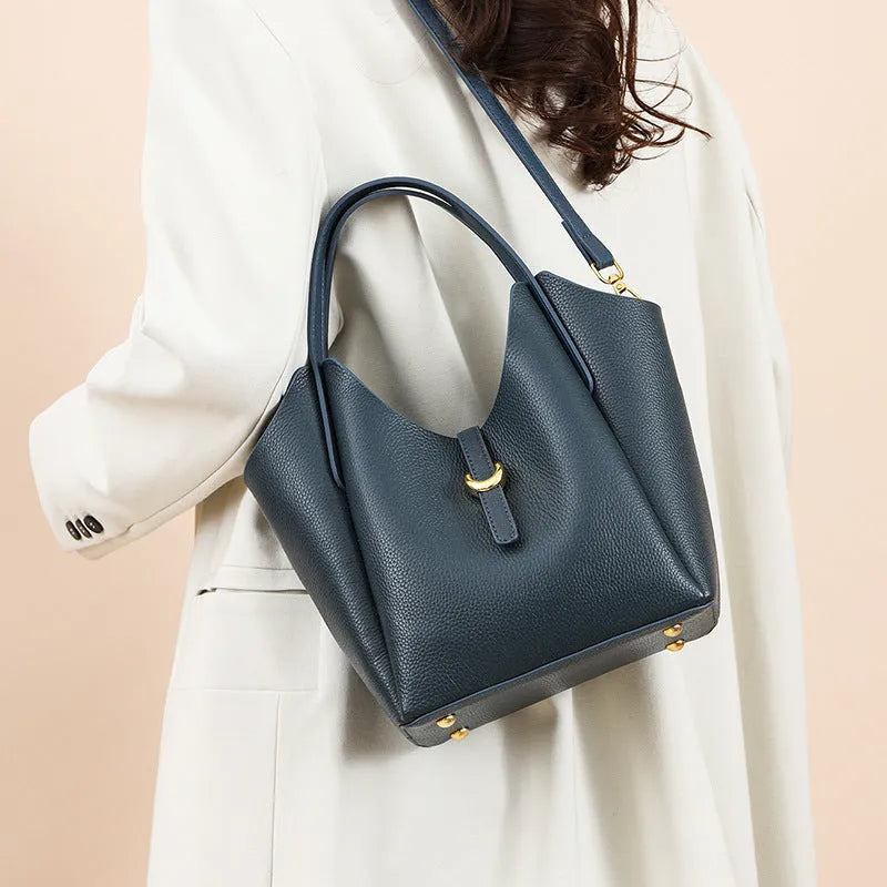 Genuine cowhide leather women's bucket bag in retro style with contrast stitching.