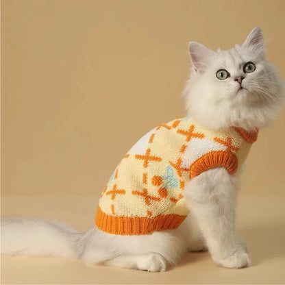 Orange cherry diamond pattern cat sweater shown on feline model with size label