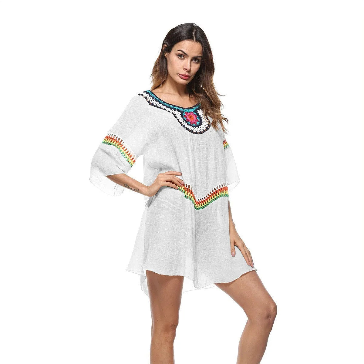 Crocheted white beach cover-up with open-knit design, worn over swimsuit, demonstrating UPF 50+ sun protection.