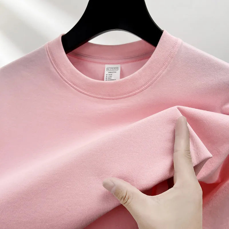 Men's thin cotton drop shoulder t-shirt on a hanger, shown in a light colour.