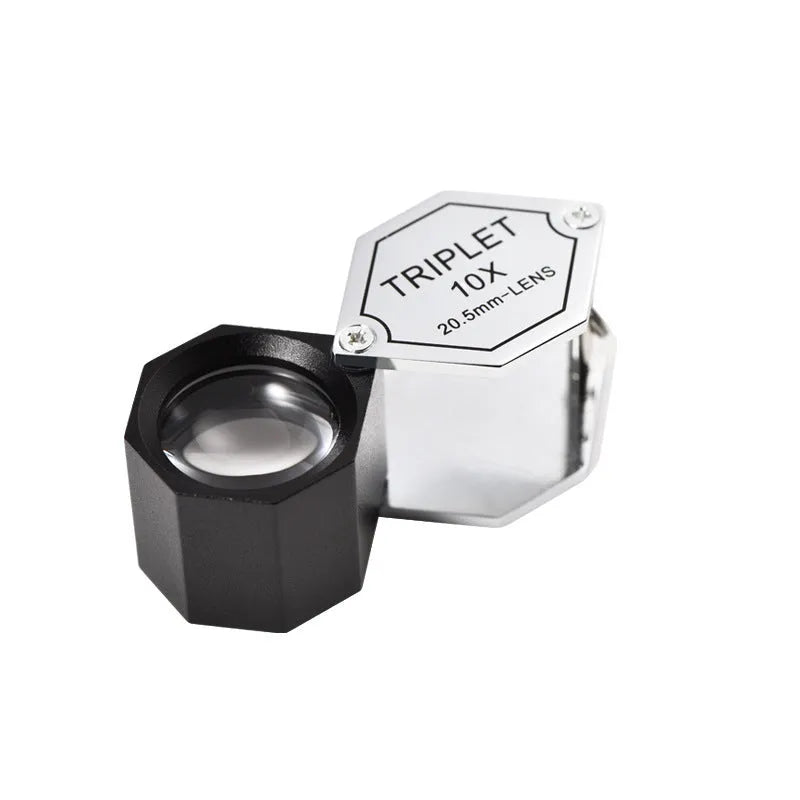 Handheld metal magnifying glass with optical glass lens for jewellery and coin inspection.