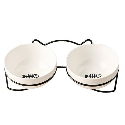 White ceramic pet bowl with cat paw print in a black iron stand with cat ear details