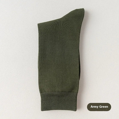 Pair of solid-colour men's mid-calf socks made from combed cotton on a wooden background