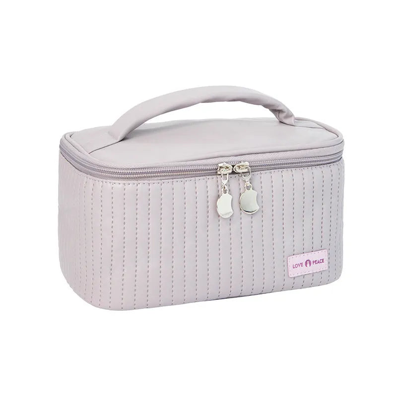 Open-top pastel pink PU leather makeup bag with a flat base, showing interior space.