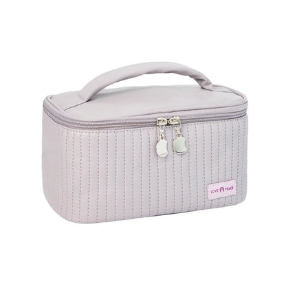 Open-top pastel pink PU leather makeup bag with a flat base, showing interior space.