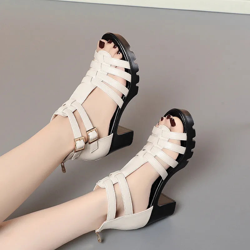 Women's beige high heels with hollow-out design, rhinestones, and an ankle buckle.
