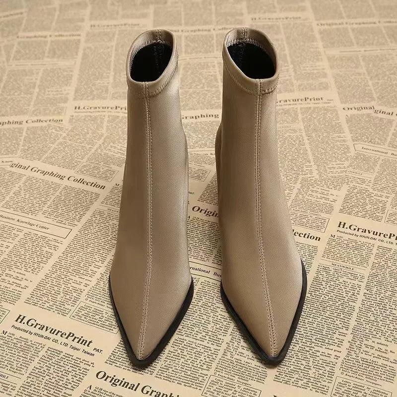 Women's khaki stretch suedette pointed toe ankle boots with a mid block heel on a white background.