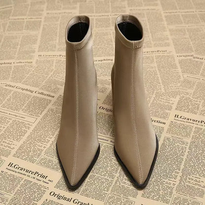 Women's khaki stretch suedette pointed toe ankle boots with a mid block heel on a white background.