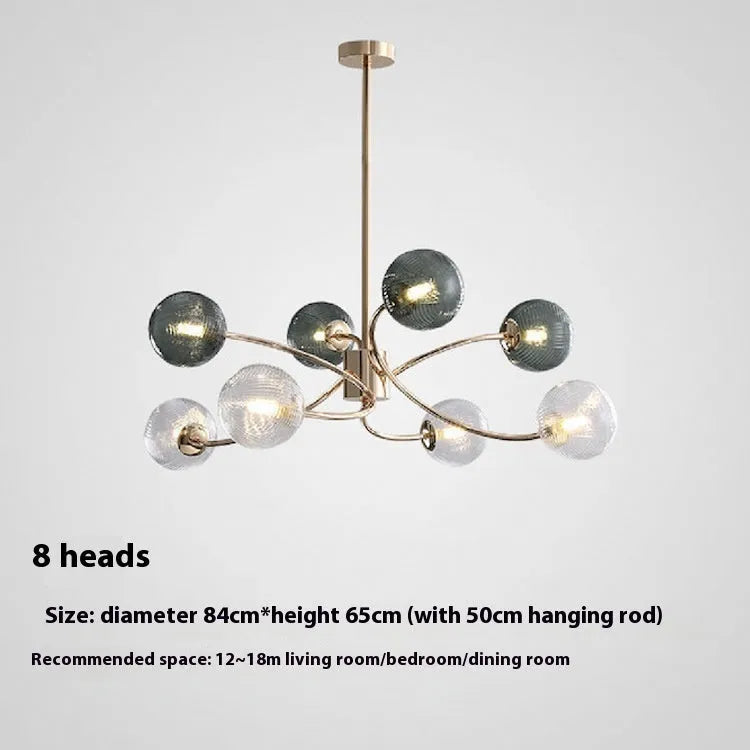 Modern Nordic-style chandelier with multiple green glass shades hanging at different heights.