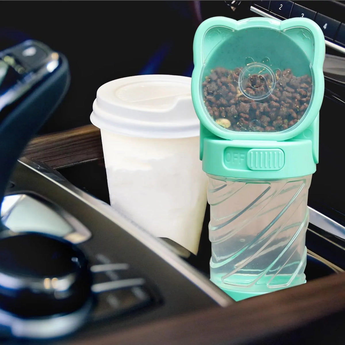 Green 3-in-1 pet water bottle with strap, showing water dispenser, food container, and waste bag dispenser for outdoor use