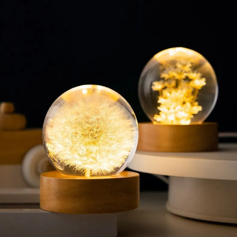 USB-powered 3D dandelion crystal ball night light on a natural beech wood stand.