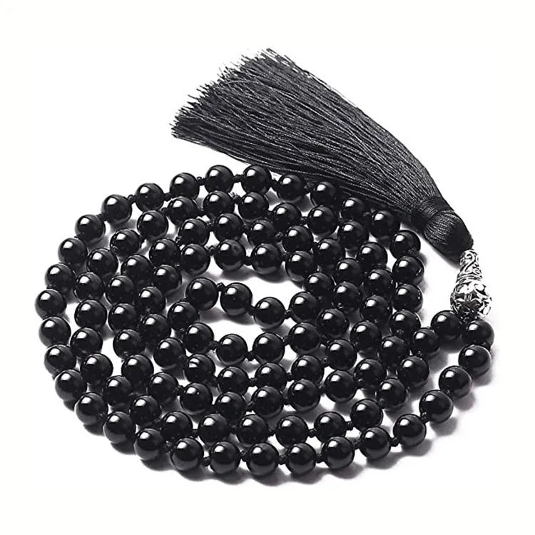 Long multi-coloured agate and stone tassel necklace with geometric beads on a white background.