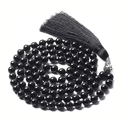 Long multi-coloured agate and stone tassel necklace with geometric beads on a white background.