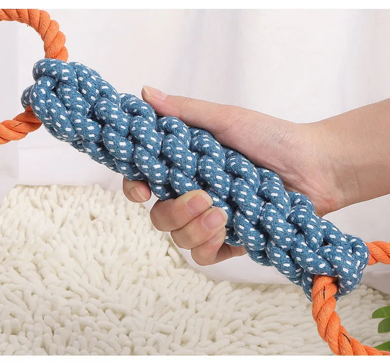 Blue braided bone-shaped cotton rope dog toy with two end rings on a white background.