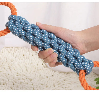 Blue braided bone-shaped cotton rope dog toy with two end rings on a white background.