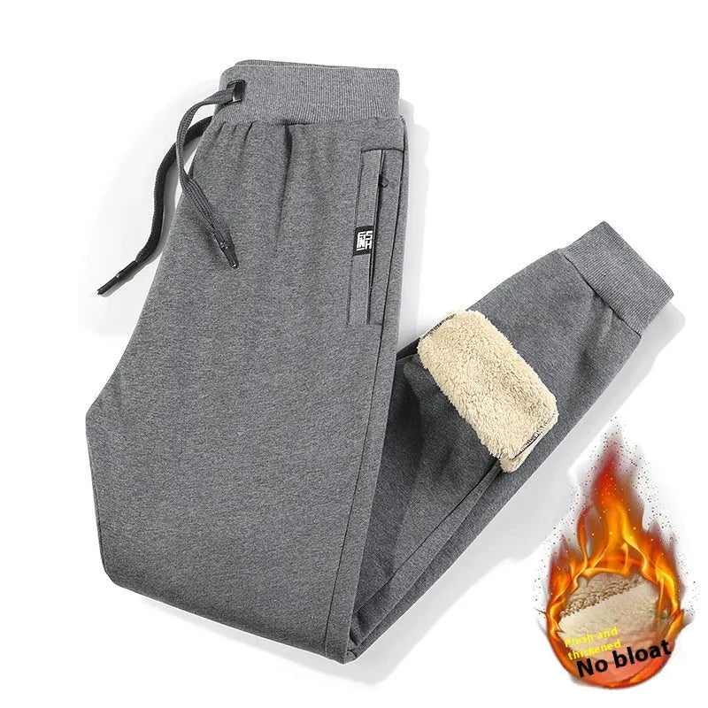 Men's grey fleece-lined cotton track pants with an elasticated waist, shown in an oversized fit.