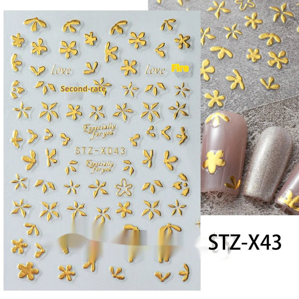 Assortment of black and silver nail sticker designs including cartoon and French tip patterns on a plastic sheet.