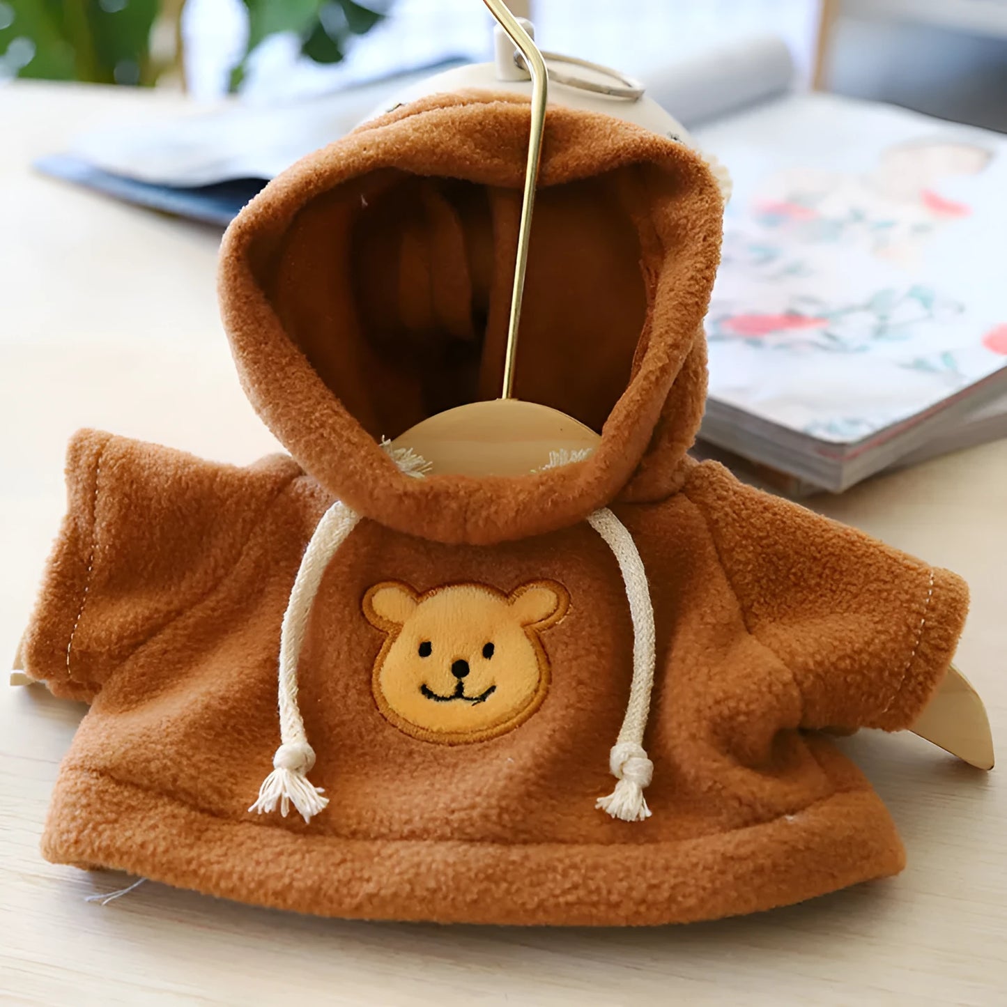 Cloth dog hoodie sweater in blue, shown in medium 23cm size on a small dog.