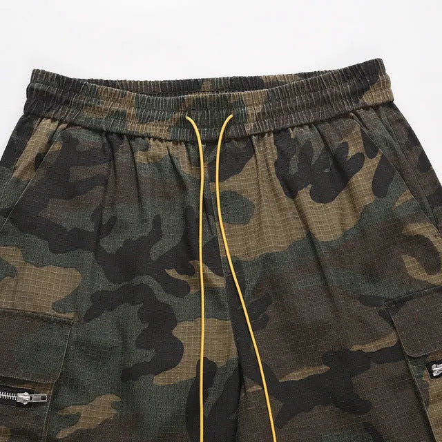 Green H215 washed camouflage cotton workwear shorts on a mid-waist, loose-fit model
