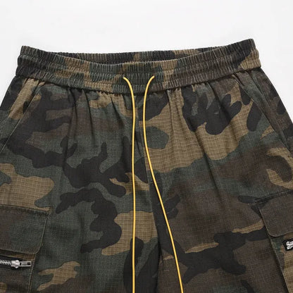 Green H215 washed camouflage cotton workwear shorts on a mid-waist, loose-fit model