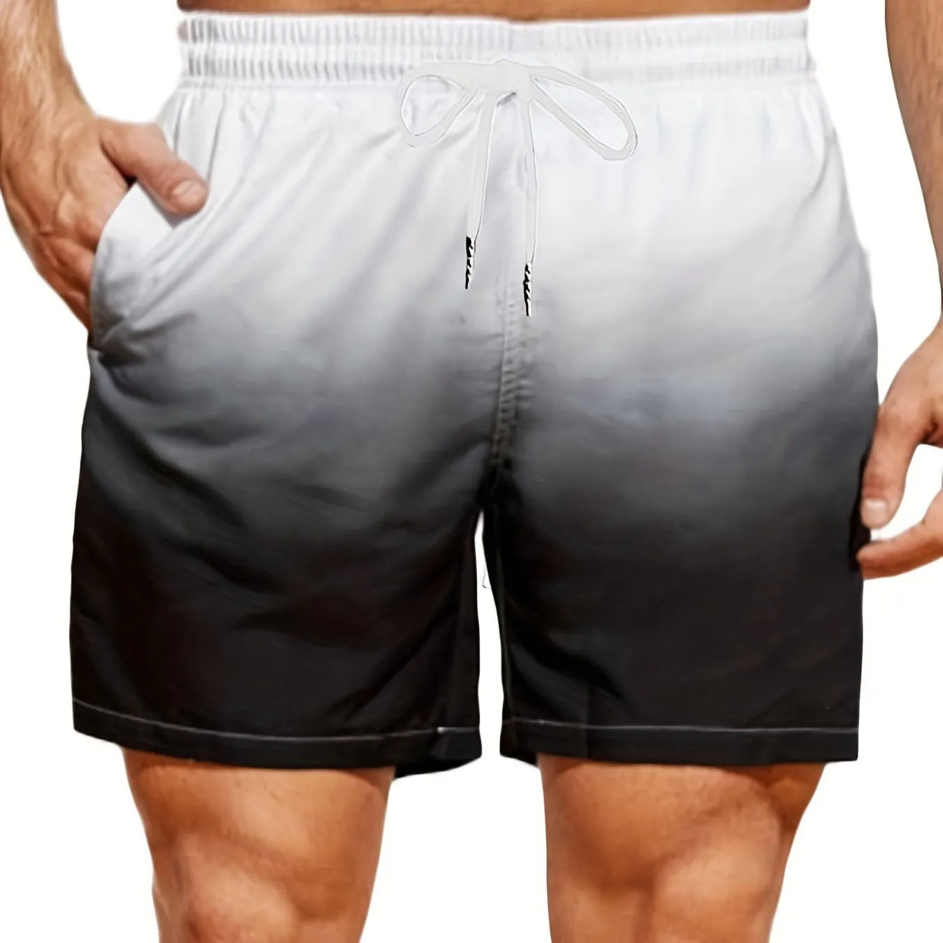 Men's grey gradient print sports shorts made from breathable mesh fabric, shown on a model.