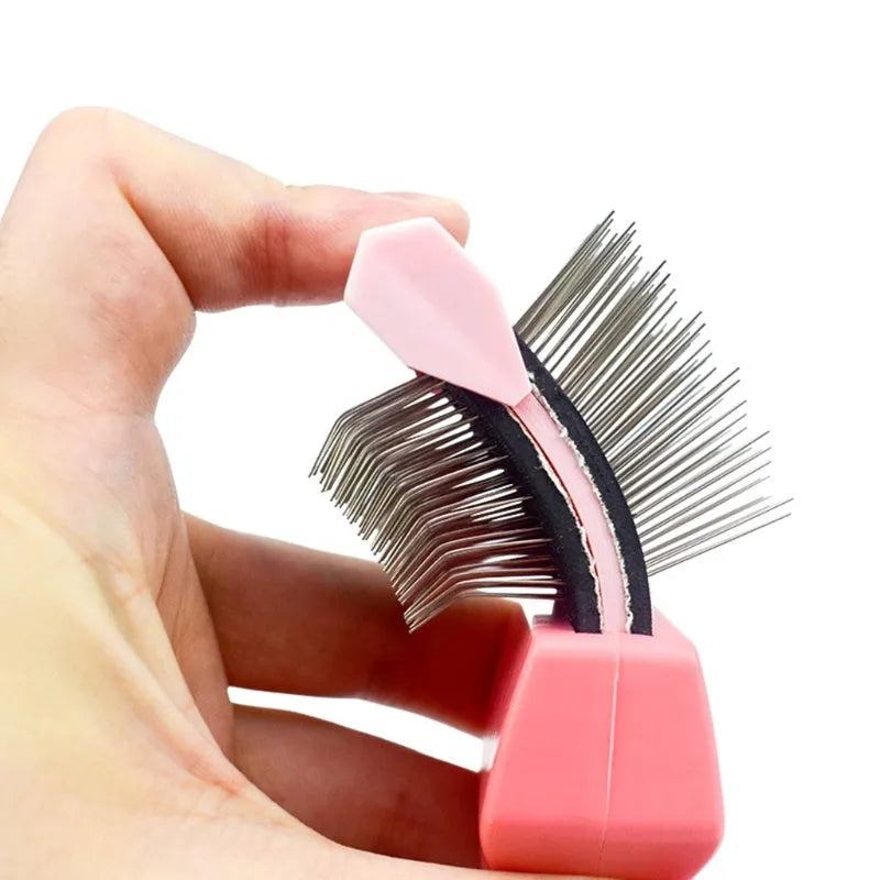 Blue double-sided pet brush for dogs and cats with stainless steel pins on a wooden table