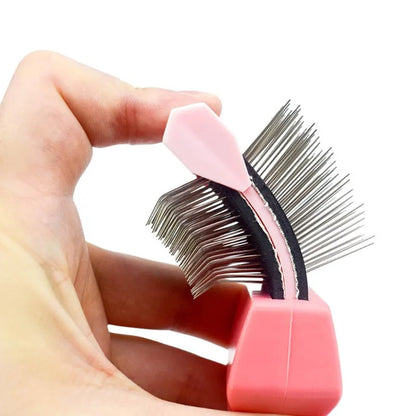 Blue double-sided pet brush for dogs and cats with stainless steel pins on a wooden table