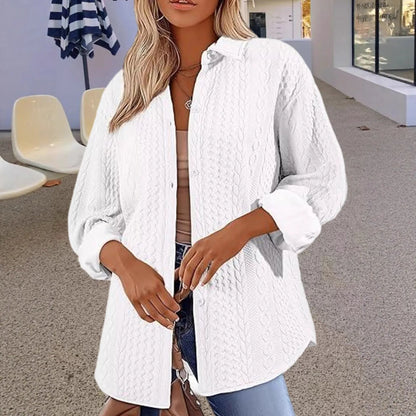Women's solid colour long-sleeved cardigan sweater in black, shown in a commute-style setting.