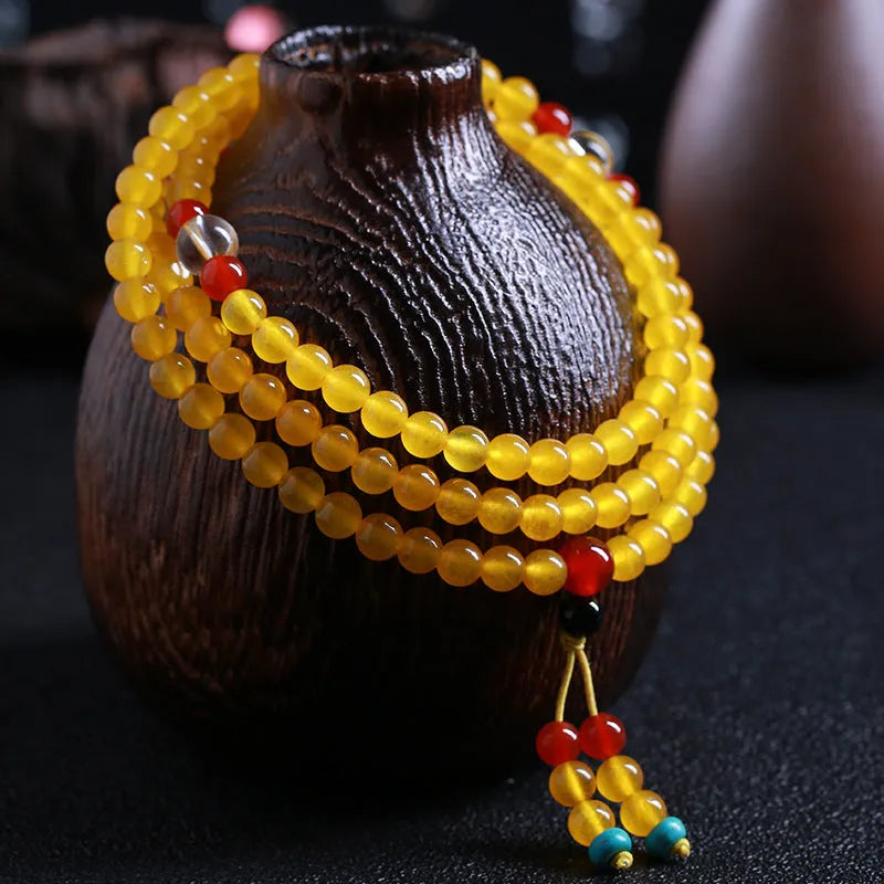 Crystal canary stone 108-bead necklace and bracelet set with geometric beads and lucky cat charm.
