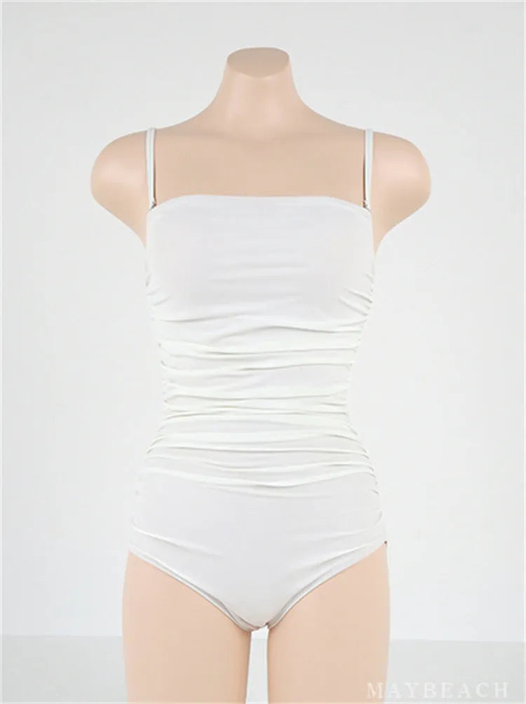Sling style one-piece swimsuit with belly pleats in solid colour options