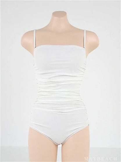 Sling style one-piece swimsuit with belly pleats in solid colour options