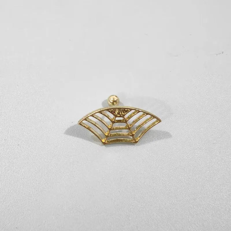 Close-up of a geometric spider web design on a gold-toned metal stud earring.