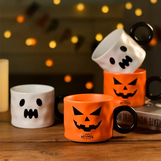 Festive pumpkin-themed ceramic mugs in orange and white colors, perfect for Halloween celebrations and enjoying hot or cold beverages