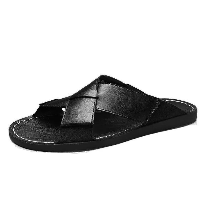 Men's black frosted pigskin leather slip-on sandals with a sewn rubber sole on a beach background.
